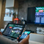 One senior man watches soccer match and bets on the game.